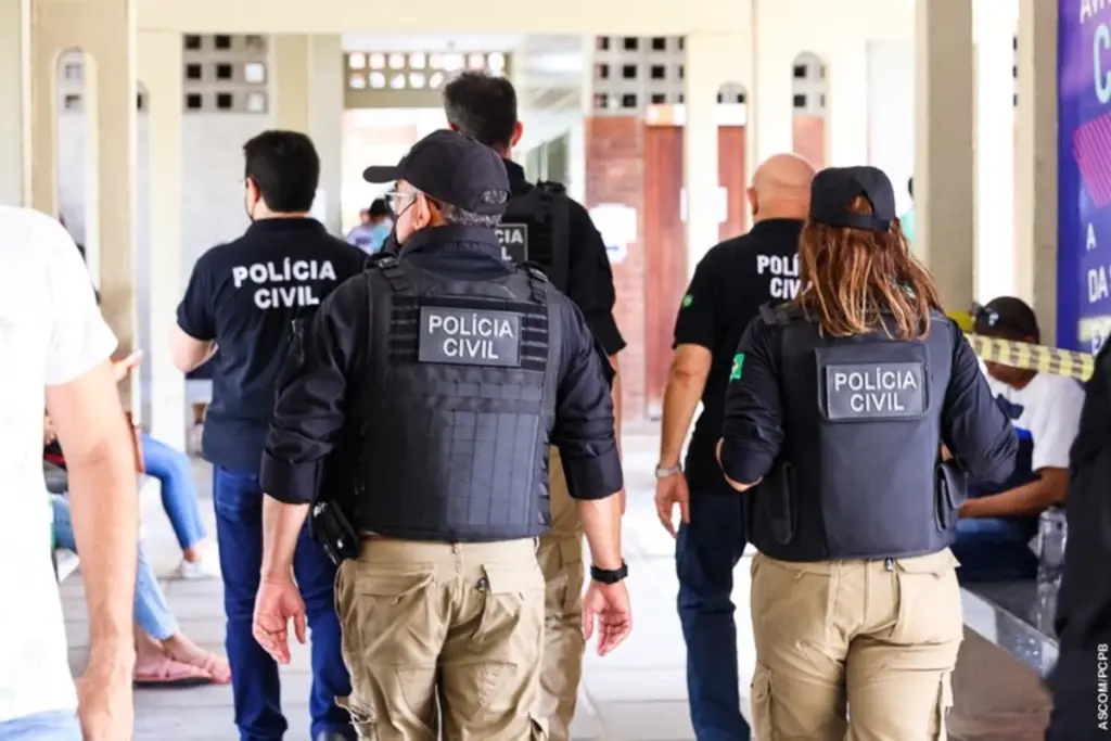 Policiais Civis de costas com colete andando